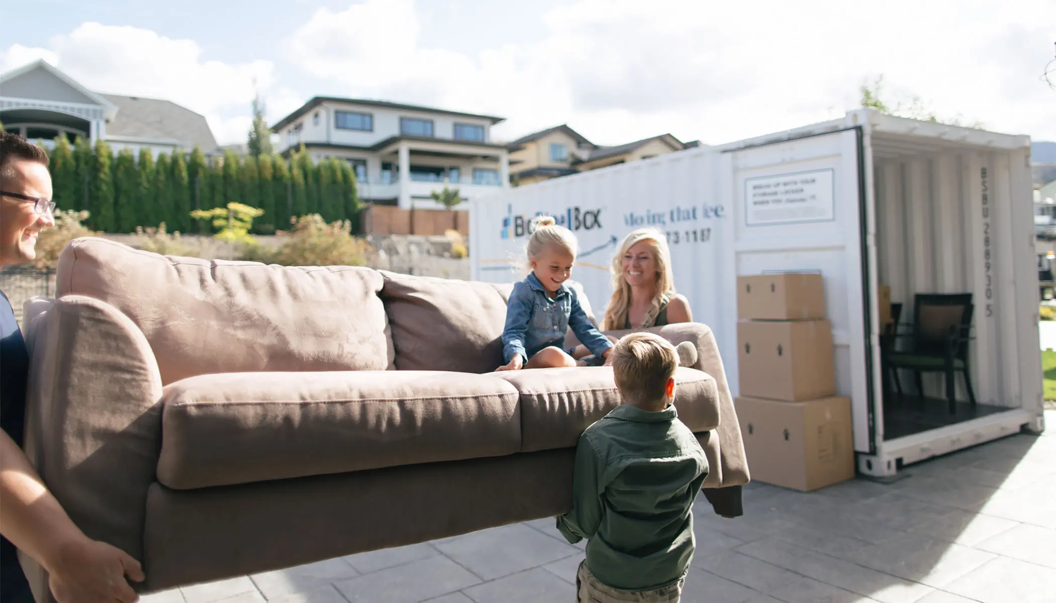 Family loading a BigSteelBox moving container