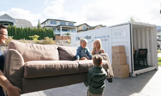 Family loading a BigSteelBox moving container