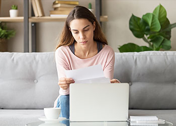 Woman at computer reviewing financials