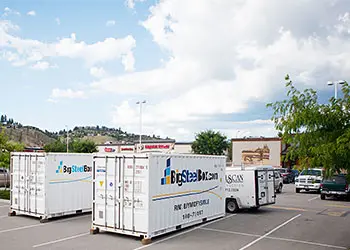 Portable storage containers in business parking lot